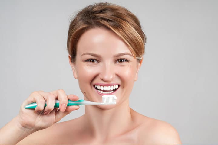 girl brushing teeth with whitening toothpaste